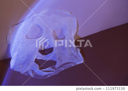 Cosmetic facial mask with serum under blue light 111973130