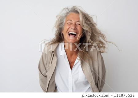 Portrait of a happy senior woman laughing isolated over white background 111973522