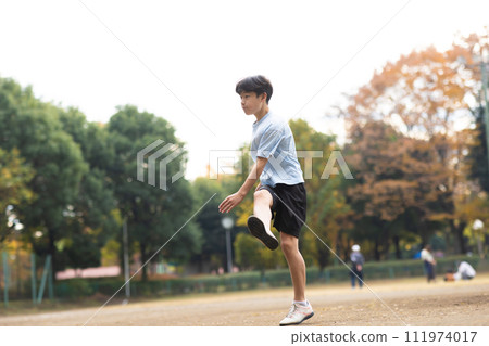 Elementary school boys enjoying soccer in the park 111974017