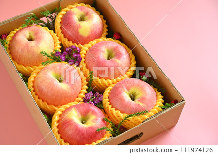 beautiful apple in the box on pink backgrond, healthy fruit beautiful apple in the box on pink backgrond, healthy fruit 111974126
