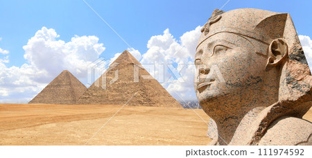 Horizontal banner with stone sphinx statue and famous Great Pyramids of Chephren and Cheops, Giza pyramid complex (Giza Necropolis), Cairo, Egypt. Two Great Pyramids in desert and face of sphinx Horizontal banner with stone sphinx statue and famous Great Pyramids of Chephren and Cheops, Giza pyramid complex (Giza Necropolis), Cairo, Egypt. Two Great Pyramids in desert and face of sphinx 111974592