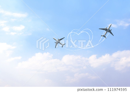 Horizontal nature background with two aircrafts drawing a heart in the sky. Flight route of aircraft in shape of a heart. The concept of the love of travelling 111974595