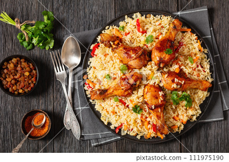 fried chicken drumsticks over rice pilaf, top view 111975190