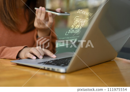 Woman scanning QR code with her phone login on laptop. User privacy security and Cybersecurity concept 111975554