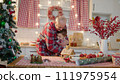 Senior man and his grandchildren together at the kitchen on Christmas holidays 111975954