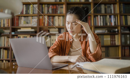 Tired female writer having headache, resting from work on laptop, eyestrain 111976163