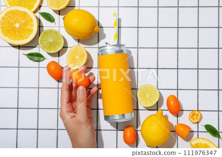 A metal can with fresh lemon halves 111976347