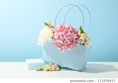 Beautiful, fresh flowers on a blue background. 111976417