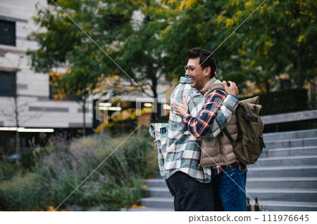 Best friends meeting, happy to see each other, man's hug. Concept of male friendship, bromance. 111976645