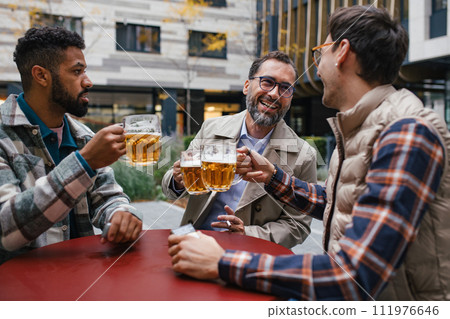 Best friends togehter, drinking beer and talking in bar in city. Concept of male friendship, bromance. 111976646