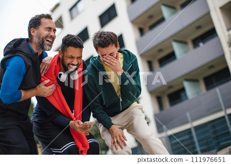 Best friends playing sport outdoors, having fun, competing. Playing basketball at a local court, enjoying exercise together. Concept of male friendship, bromance. 111976651