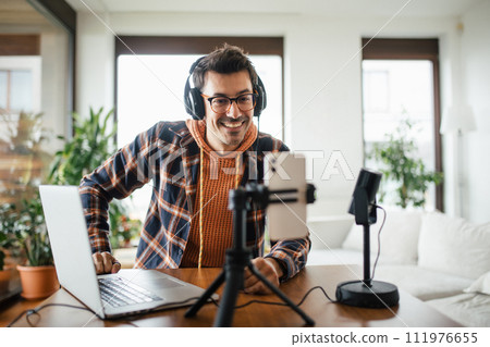 Man as mental health influencer making video for social media. Influencer, doing telepsychology, creating online content about mental health, well-being, teaching breath exercises. 111976655