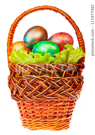 Vibrant Hand-Painted Easter Eggs in Wicker Basket Isolated 111977982