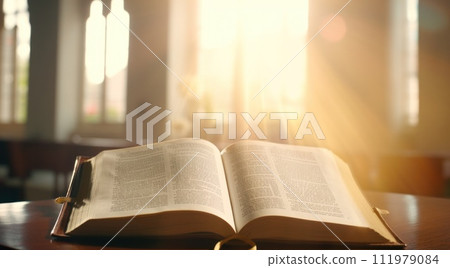 open bible with church silhouette in front of it 111979084