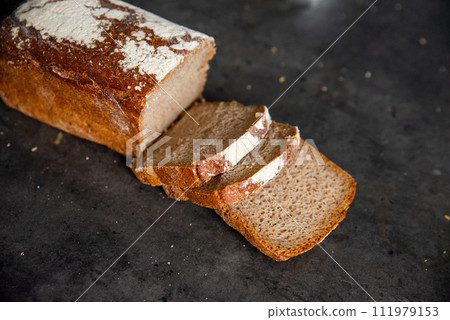 rye bread, sourdough, cut into pieces, placed on a stone counte 111979153