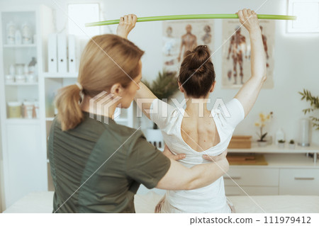 therapist woman in massage cabinet conducting examination 111979412