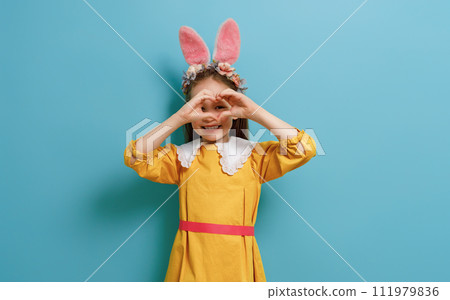 child wearing bunny ears on Easter day 111979836