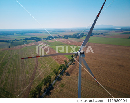 Aerial view of wind turbine in countryside area 111980004