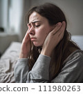 A woman who looks sick and in pain 111980263