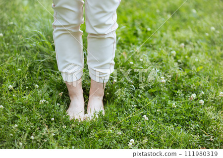 Closeup on woman in meadow outdoors Closeup on woman in meadow outdoors 111980319