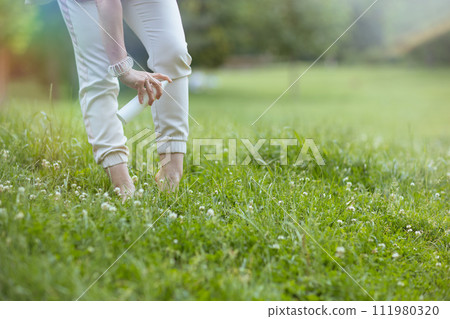 Closeup on modern woman in white shirt with repellent spray Closeup on modern woman in white shirt with repellent spray 111980320