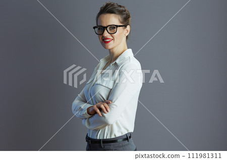 happy trendy 40 years old woman employee against gray 111981311