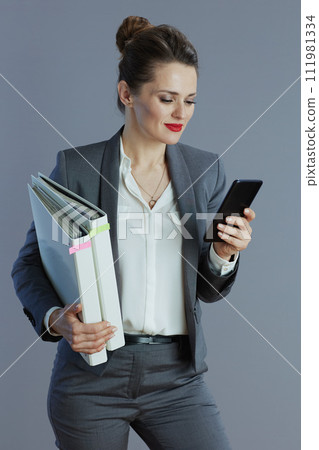 modern 40 years old woman worker against gray background modern 40 years old woman worker against gray background 111981334