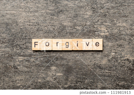 Forgive word written on wood block. Forgive text on cement table for your desing, Top view concept Forgive word written on wood block. Forgive text on cement table for your desing, Top view concept 111981913