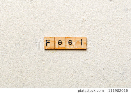 feel word written on wood block. feel text on table, concept 111982016