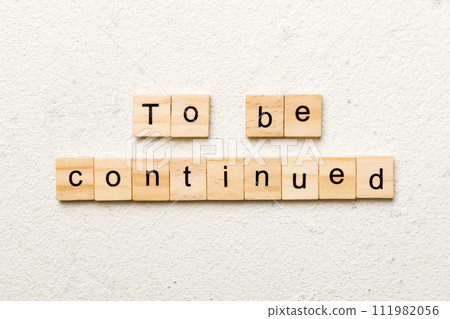 To be continued word written on wood block. To be continued text on cement table for your desing, concept To be continued word written on wood block. To be continued text on cement table for your desing, concept 111982056