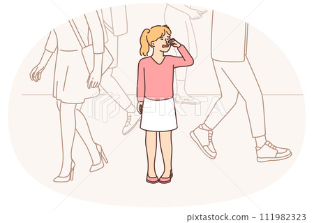Little unhappy girl crying while standing on street in public place after getting lost in big city 111982323
