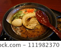 Ramen Japanese noodle dish served in a broth with sliced pork, green onion, boiled egg 111982370