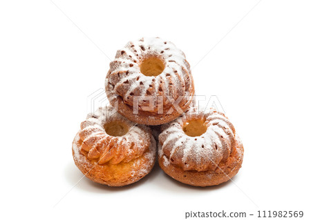 Muffins with powdered sugar isolated on white background. Homemade baked goods close-up 111982569