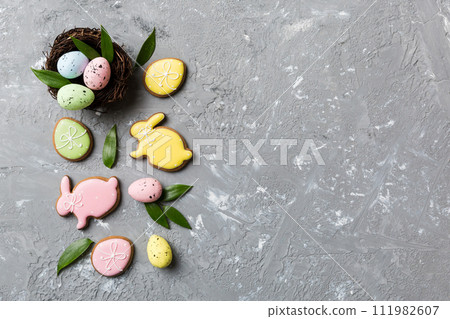 Colorful easter eggs in nest on table background with copy space top view Colorful easter eggs in nest on table background with copy space top view 111982607