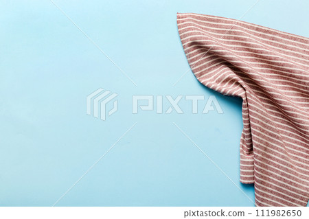 top view with red empty kitchen napkin isolated on table background. Folded cloth for mockup with copy space, Flat lay. Minimal style top view with red empty kitchen napkin isolated on table background. Folded cloth for mockup with copy space, Flat lay. Minimal style 111982650