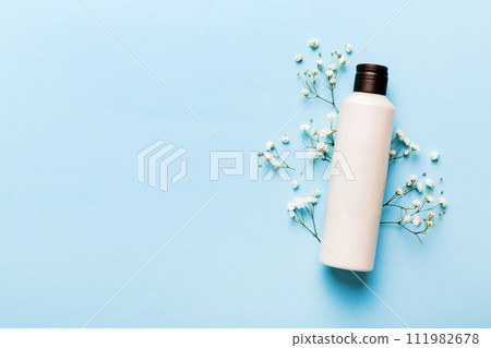 Fancy healthcare bottles for cream with gypsophila branch. Natural oranic spa cosmetics concept. Mockup, template, Top view 111982678