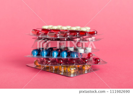 too many different pill cartridges stacked. selective Focus. Packs of blister pills with tablets. Colored pastilles packages. A pile of medicine in blister packs. Pharmaceutical blister packs too many different pill cartridges stacked. selective Focus. Packs of blister pills with tablets. Colored pastilles packages. A pile of medicine in blister packs. Pharmaceutical blister packs 111982690