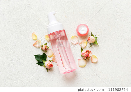 Fancy healthcare bottles for serum, micellar, tonic, toner, lotion, water and cream with rose flower. Natural oranic spa cosmetics concept. Mockup, template, Top view Fancy healthcare bottles for serum, micellar, tonic, toner, lotion, water and cream with rose flower. Natural oranic spa cosmetics concept. Mockup, template, Top view 111982734