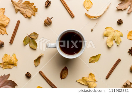 Flat lay composition with colorful Autumn cup of coffee and leaves on a color background. top view Flat lay composition with colorful Autumn cup of coffee and leaves on a color background. top view 111982881