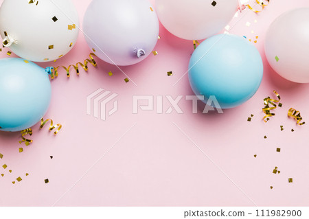 Background with fastive air balloons of round shape and confetti, multicoloured top view. Birthday party background 111982900