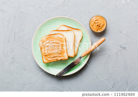 Peanut butter sandwiches or toasts on light table background.Breakfast. Vegetarian food. American cuisine top view vith copy space 111982989