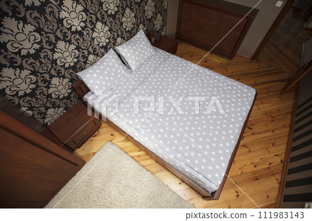 Interior of a small bedroom with a top view bed. Interior of a small bedroom with a top view bed. 111983143