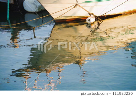 silhouette of a ship reflected in the sea silhouette of a ship reflected in the sea 111983220