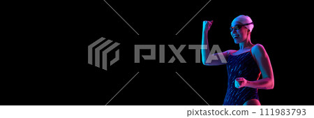 Banner. Young attractive lady rejoice of victory vibrant neon light against black studio background with negative space to insert text. Banner. Young attractive lady rejoice of victory vibrant neon light against black studio background with negative space to insert text. 111983793