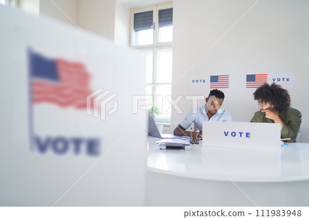 Members of electoral commission in polling place on election day, usa elections. 111983948