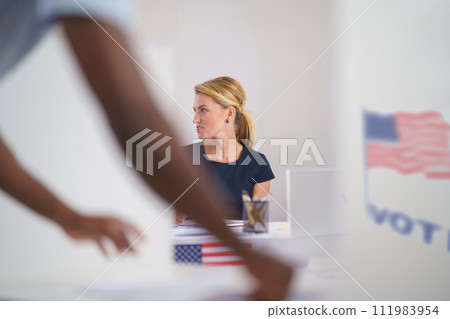 Member of electoral commission in polling place on election day, usa elections. Member of electoral commission in polling place on election day, usa elections. 111983954
