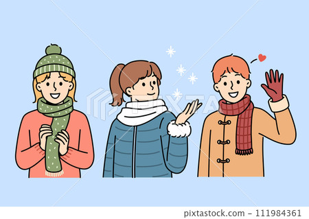 Little kids in winter clothes stand under falling snow, rejoicing at onset of christmas weekend Little kids in winter clothes stand under falling snow, rejoicing at onset of christmas weekend 111984361