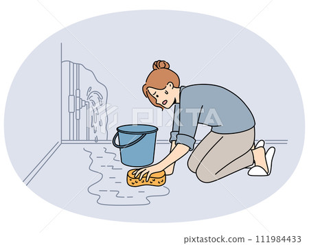 Worried woman clean water from burst pipe 111984433