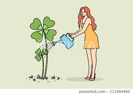 Woman waters yarrow clover growing from ground in preparation for st. Patrick day celebrations 111984460