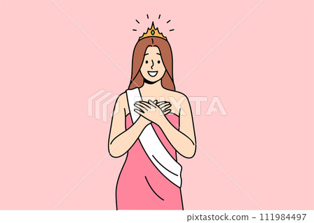 Woman won beauty contest smiles with hands on chest, dressed in dress with winner ribbon and crown Woman won beauty contest smiles with hands on chest, dressed in dress with winner ribbon and crown 111984497